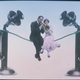 man and woman sitting on telephone wire